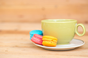 macaron cakes with coffee or macaroon on wood background, sweet and colorful dessert, vintage pastel colors tone.