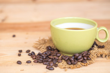 smile coffee cup with heart on wood background, happy love drink coffee concept.