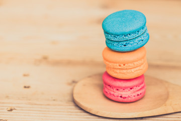 macaron cakes or macaroon on wood background, sweet and colorful dessert, vintage pastel colors tone.