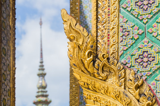 Thai antique art decoration buddhist temple wall, golden angle wallpaper for background background design.