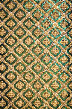 Thai antique art decoration buddhist temple wall, golden angle wallpaper for background background design.