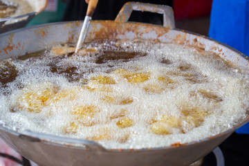 Deep frying, cooking process food is submerged in hot oil.