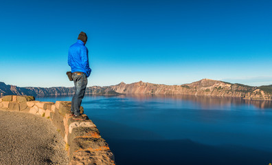 scenic view of a man stand over look to Crater lake National park.