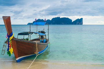 Naklejka na ściany i meble View of boat in the port of Ko Phi Phi island over turquoise sea and blue sky background, Thailand