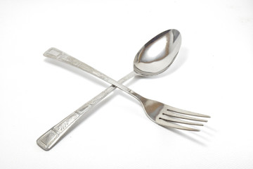 Silver steel fork and spoon isolated on white background