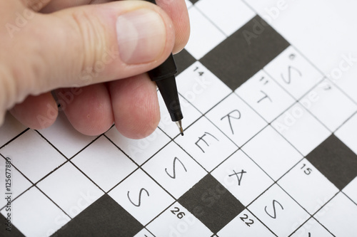 "A person is doing a crossword puzzle. The word stress is ...