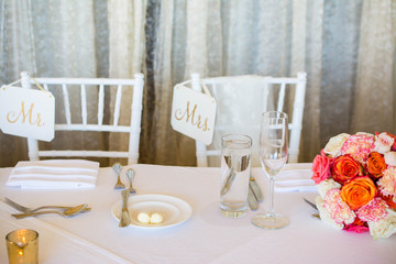 Wedding decoration with pink flowers, gold candels and rose. Romantic. Sign Mrs. and Mr.