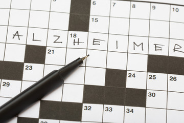 Crossword puzzle with a word alzheimer and a black pencil. Good training for brains especially for elderly people.