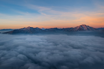 Mountains sprout from low clouds