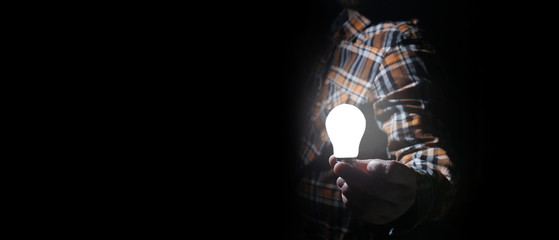 man in dark with glow bulb
