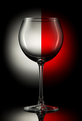 Empty wine glass on a color background.