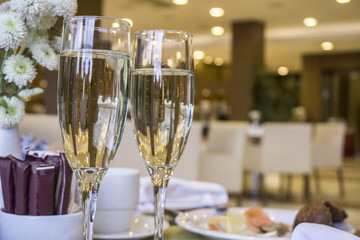 Two glasses of champagne waiting to be served by guests