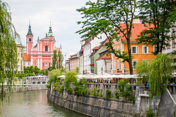 Fototapeta na wymiar Ljubljana's city center: river Ljubljanica, Triple Bridge (Tromostovje), Preseren square and Franciscan Church of the Annunciation; Ljubljana, Slovenia, Europe