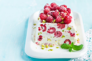 semifredo, italian ice cream dessert, with raspberry and pistach
