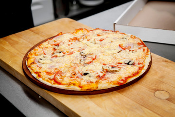 Pizza with ham, pepper and olives
