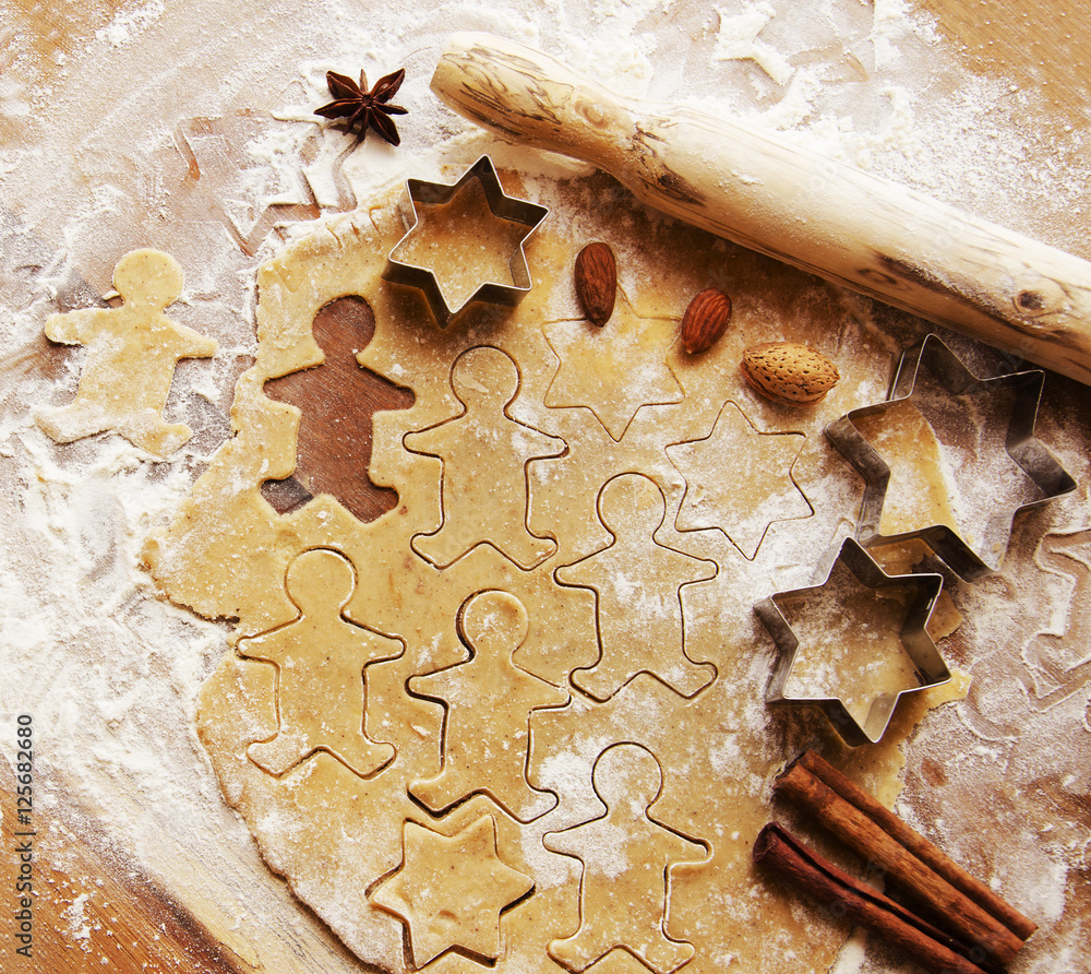 Wall mural gingerbread dough with molds for baking and cinnamon, selective focus