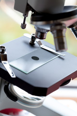 close up macro microscope with blood sample in the laboratory