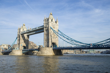Fototapeta na wymiar Scenic landscape view of Tower Bridge standing tall in afternoon light above the River Thames as viewd from the South Bank in London, England