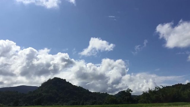 time lapse white clouds on the blue sky in the countryside of Thailand, silhouette