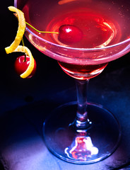Fototapeta na wymiar Cherry cocktail glass with cherry berry on black background. Top view.