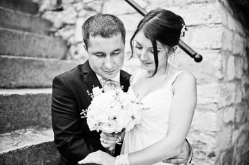 Newly wed in their wedding day near old wooden gate