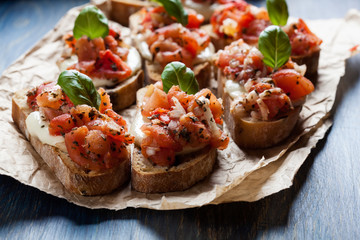 Italian bruschetta with roasted tomatoes, mozzarella cheese and