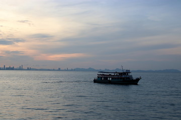 Silhouette of a passenger ferry boat during sunset