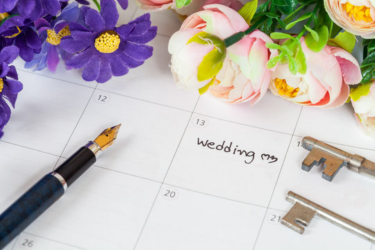 word wedding on calendar with sweet flowers and pen  ,love conce