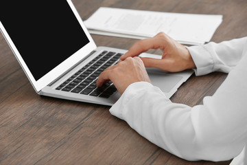 Naklejka premium Successful businesswoman working with laptop in office, close up view