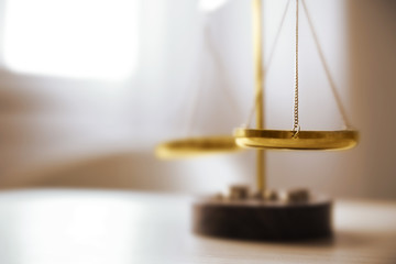 Justice scales on table in the room