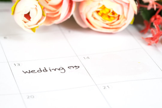 word wedding on calendar with sweet flowers   ,love concept