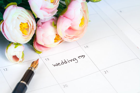 word wedding on calendar with sweet flowers and pen  ,love conce