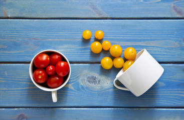 Red and yellow tomatoes on a blue background