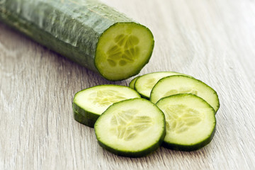 Sliced cucumber on a wooden background