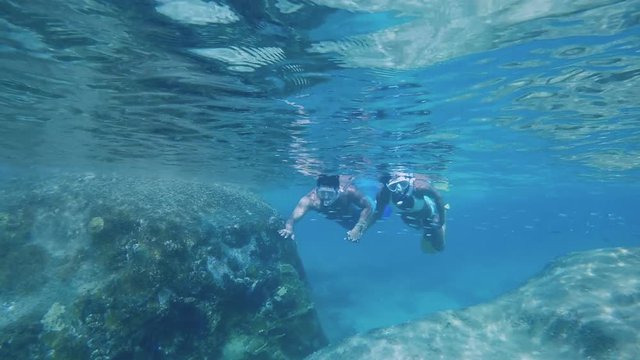 couple snorkeling underwater in Virgin Gorda, British Virgin Islands