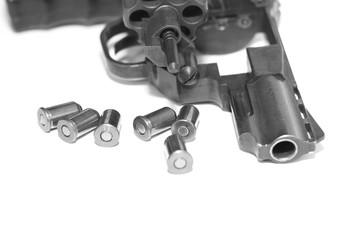 Revolver with bullets close-up isolated on white background / black and white photo in a retro style