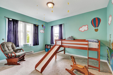 Cheerful kid's bedroom with green painted walls