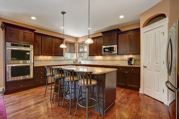 Well remodeled kitchen room interior with dark wood cabinets