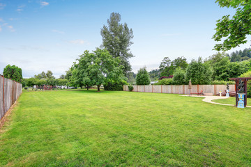 Fototapeta na wymiar Large spacious backyard area, filled with green grass
