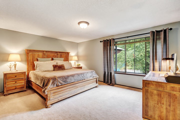 American Bedroom interior with queen size bed and wooden desk