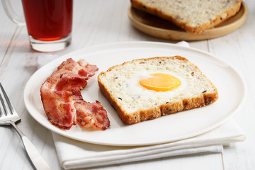 egg in a hole and crispy bacon