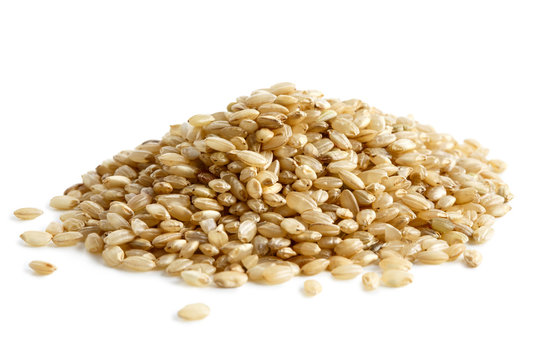 Pile of short grain brown rice isolated on white.