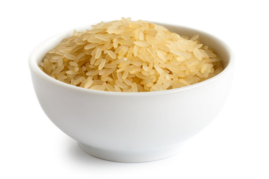 Bowl of long grain parboiled rice isolated on white.