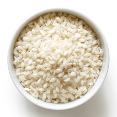 Bowl of Arborio short grain white rice isolated on white from above.