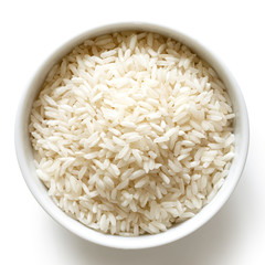 Bowl of long grain white rice isolated on white from above.