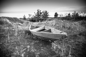 Abandoned wooden boat in a dry land