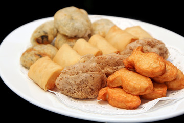 Deep Fried Fish Bean Cake, Deep Fried Mash Taro, Deep Fried Spring Roll, Deep Fried  Chinese Chives in a white dish, Dim Sum, Chinese cuisine, Food, black background.