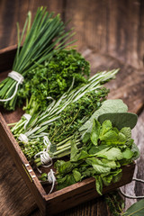 fresh aromatic herbs on kitchen table - obrazy, fototapety, plakaty