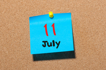 July 11th. Day 11 of month, color sticker calendar on notice board. Summer time. Close up