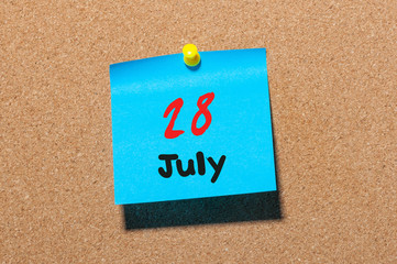 July 28th. Day 28 of month, color sticker calendar on notice board. Summer time. Close up